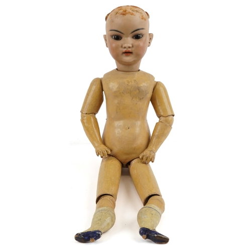 1155 - 19th century German bisque headed doll with jointed wooden limbs, indistinct marks to the back of th... 