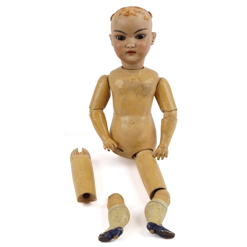 1155 - 19th century German bisque headed doll with jointed wooden limbs, indistinct marks to the back of th... 