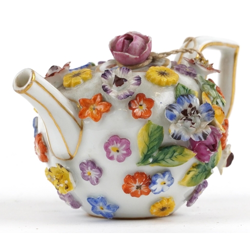 242 - Meissen, 19th century German porcelain floral encrusted miniature teapot, 9.5cm in length