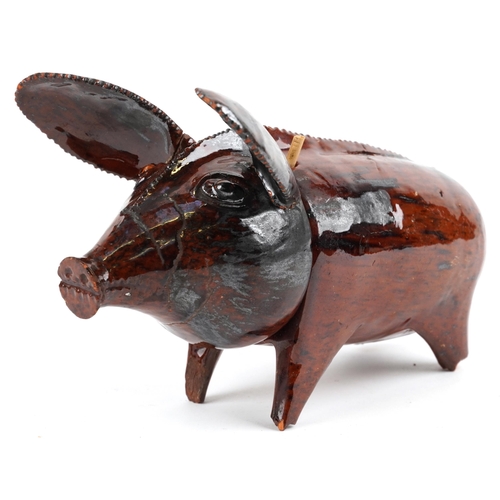 508 - Antique naive treacle glazed two section pottery pig, 20.5cm in length