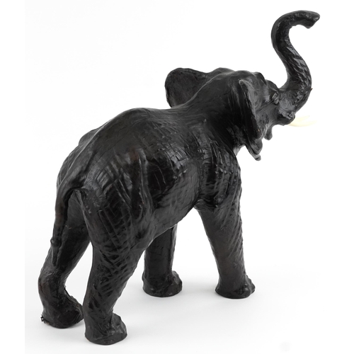 479 - Manner of Liberty & Co, large leather covered  elephant, 49cm in length