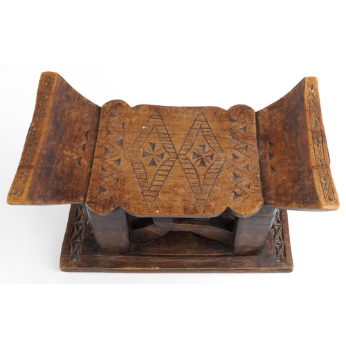 413 - African tribal interest hardwood seat in the form of a headrest, 31cm H x 43.5cm W x 19cm D