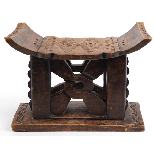 413 - African tribal interest hardwood seat in the form of a headrest, 31cm H x 43.5cm W x 19cm D