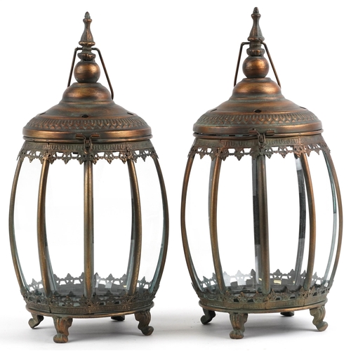 2678 - Pair of bronzed hanging lanterns with glass panels on paw feet, each 48.5cm high