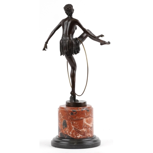 548 - Patinated bronze statuette of an semi nude Art Deco hula hoopist raised on a circular marble and bla... 