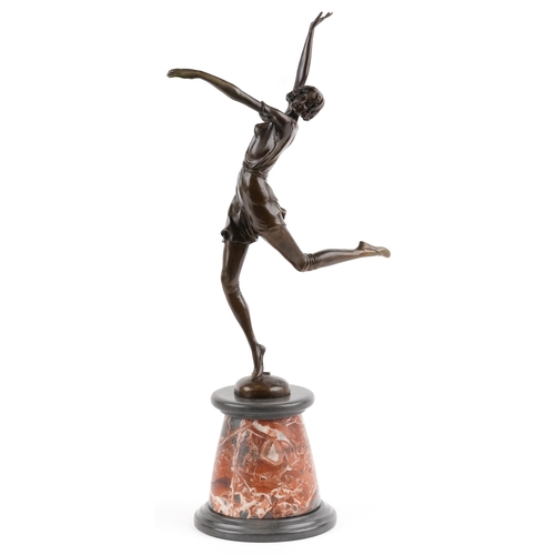 547 - Patinated bronze statuette of an semi nude Art Deco female raised on a circular marble and black sla... 