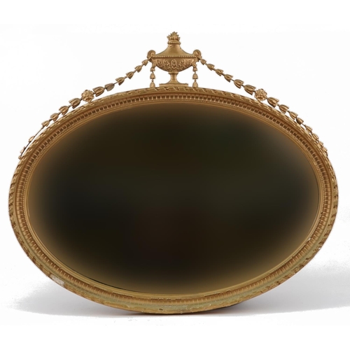 2174 - Regency style oval gilt framed wall hanging mirror with bevelled glass and swag crest, 100cm x 85cm