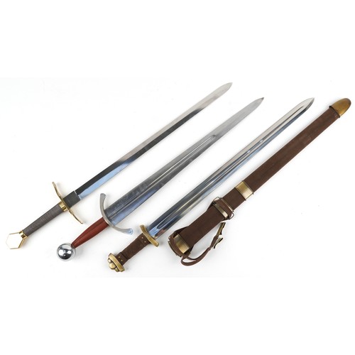 1457 - Three medieval style swords including one with sheath, the largest 24.5cm in length