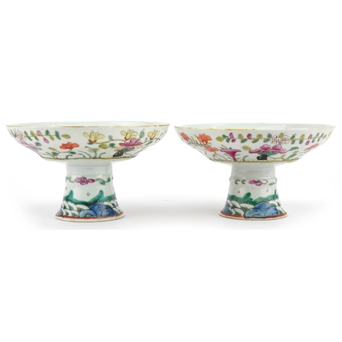 23 - Pair of Chinese porcelain stem bowls hand painted in the famille rose palette with flowers, each 9.5... 