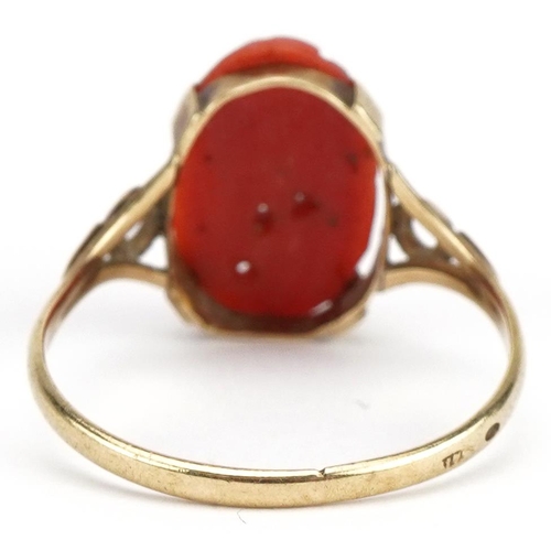 39 - Unmarked gold coral ring carved with a flower, with pierced shoulders, size S/T, 2.2g