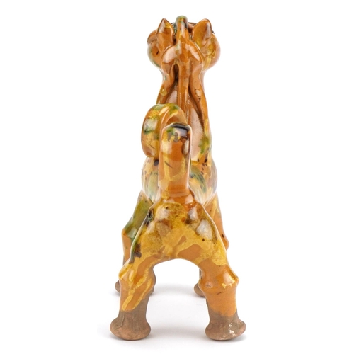 279 - Turkish Canakkale pottery ewer having a yellow and green glaze, in the form of a lion, 20cm high