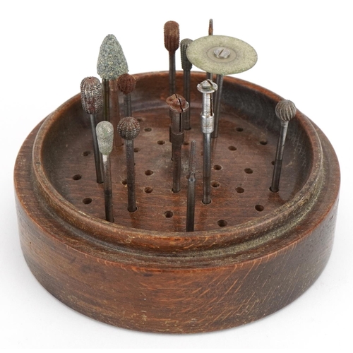 2497 - Set of chiropodist's tools raised on a hardwood stand housed under a glass dome, 12.5cm high