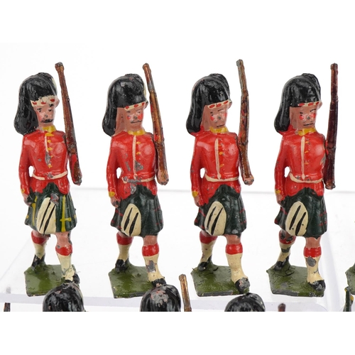 1131 - Nineteen Britains hand painted lead Gordon Highlanders soldiers and piper, some with articulated arm... 