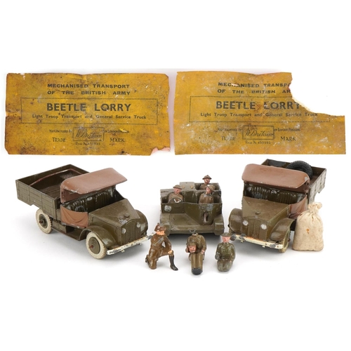 1135 - Two Britains hand painted lead military interest Beetle lorries and a Bren Gun carrier, with paper l... 