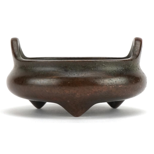 2516 - Chinese patinated bronze tripod censer with twin handles, character marks to the base, 8cm in diamet... 