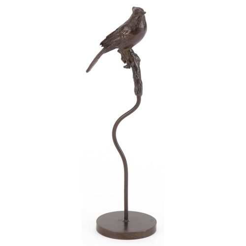 2514 - Patinated bronze sculpture of a bird perched on a branch, 17cm high