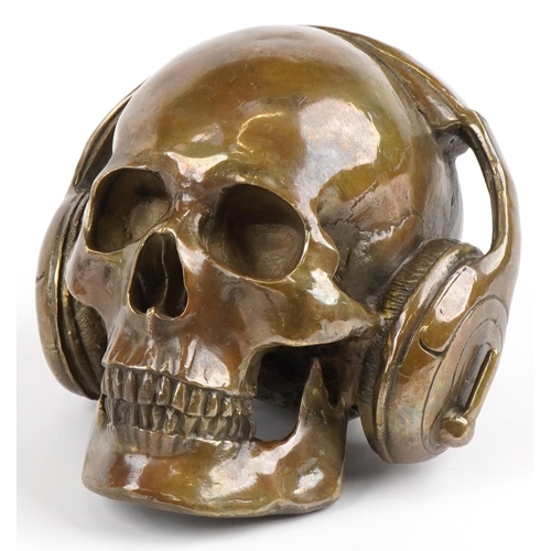 2490 - Steam Punk style patinated bronze model of a skull wearing headphones, 19cm in length