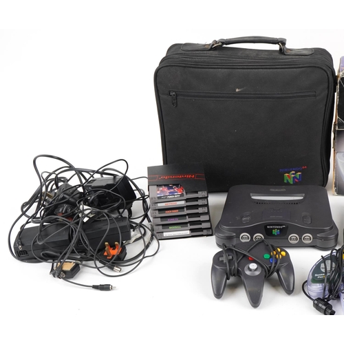 1198 - Two vintage Nintendo 64 games consoles with accessories and games including Kung Fu and Mach Rider, ... 