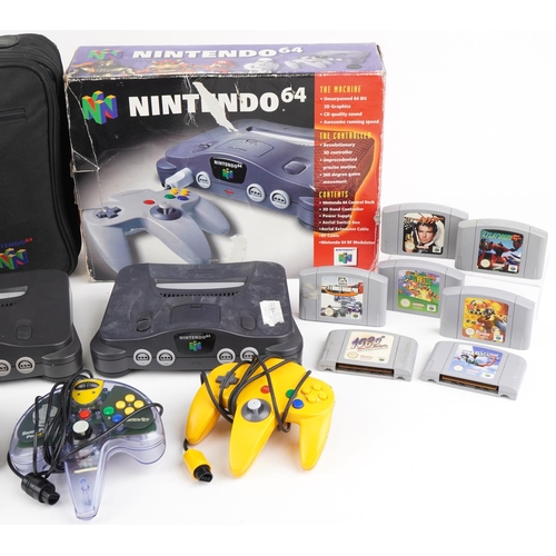 1198 - Two vintage Nintendo 64 games consoles with accessories and games including Kung Fu and Mach Rider, ... 