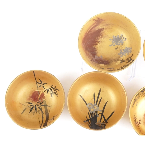 2663 - Set of six Japanese lacquered bowls hand painted with flowers and fish, each 12.5cm in diameter