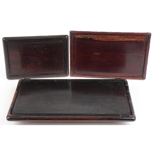 145 - Three Chinese hardwood trays, possibly Hongmu including one with twin handles having silver inlay, d... 