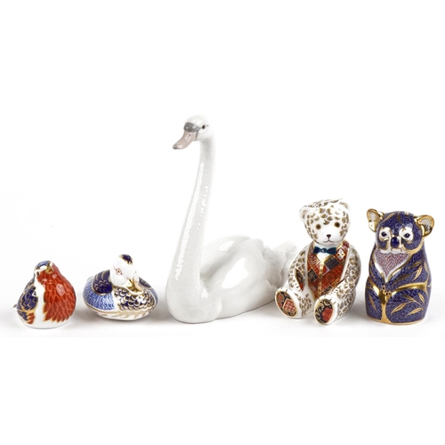 2313 - Four Royal Crown Derby animal paperweights and a Lladro swan, the paperweights comprising a bear, Ko... 