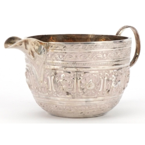 554 - Josiah Williams & Co, Victorian silver Indian design cream jug embossed with deities and animals, Lo... 