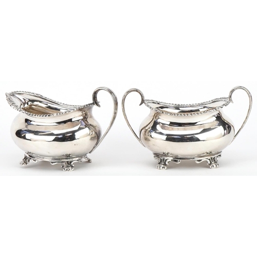 272 - Atkin Brothers, Edwardian silver cream jug and matching sugar bowl with twin handles, the largest 14... 