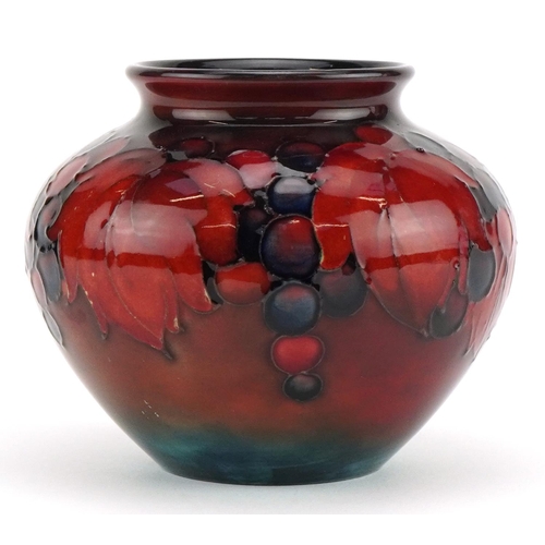 12 - William Moorcroft pottery flambe vase hand painted in the Leaves and Berry pattern, impressed and pa... 