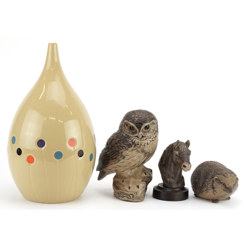 2406 - Three Poole animals comprising owl and horse head and hedgehog together we a contemporary vase, the ... 