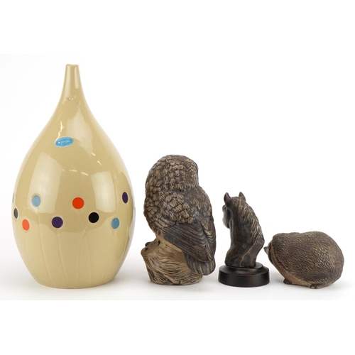 2406 - Three Poole animals comprising owl and horse head and hedgehog together we a contemporary vase, the ... 