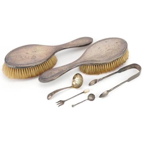 556 - Victorian and later silver objects including a pair of silver sugar tongs, sifting spoon and pair of... 