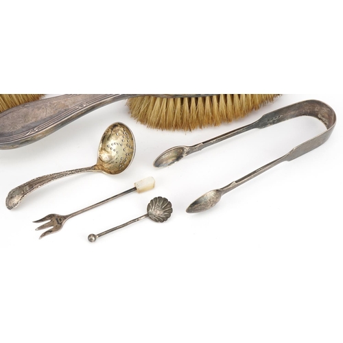 556 - Victorian and later silver objects including a pair of silver sugar tongs, sifting spoon and pair of... 