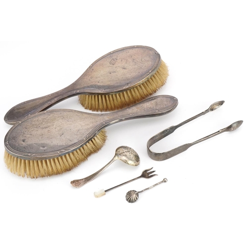 556 - Victorian and later silver objects including a pair of silver sugar tongs, sifting spoon and pair of... 