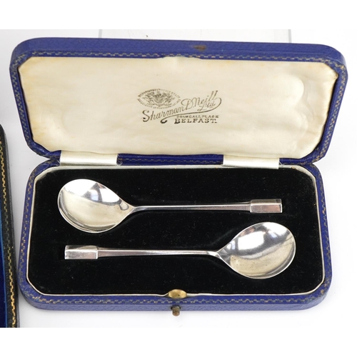 490 - Three sets of silver spoons with cases comprising set of six apostle teaspoons housed in a Harrods f... 