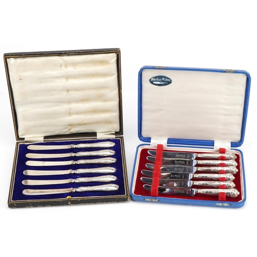 2570 - Two sets of six silver handled butter knives with fitted cases, 16.5cm in length