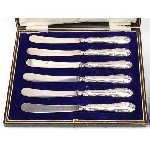 2570 - Two sets of six silver handled butter knives with fitted cases, 16.5cm in length