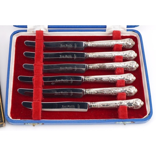 2570 - Two sets of six silver handled butter knives with fitted cases, 16.5cm in length