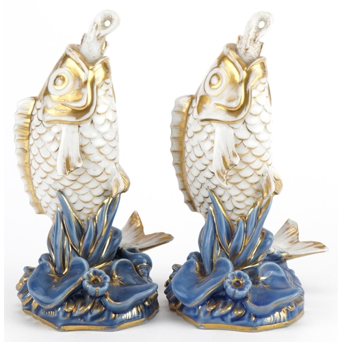 253 - Pair of 19th century continental porcelain scent bottles with stoppers in the form of fish, each 17c... 