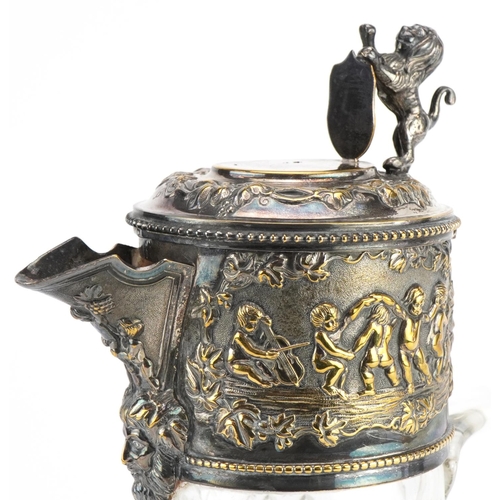 178 - 19th century cut glass claret jug with silver plated mounts embossed with a Bacchanalian scene surmo... 