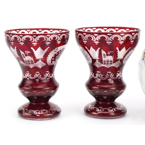 2493 - Pair of Czech Egermann ruby overlaid etched glass vases and three colourful glass paperweights, the ... 