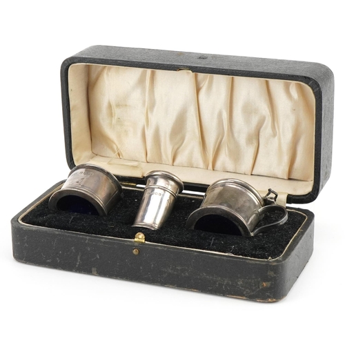 636 - Docker & Burn, George V silver three piece cruet set with blue glass liners housed in a fitted case,... 