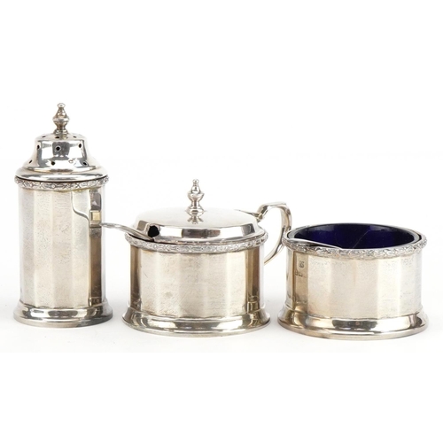 639 - William Neale & Son Ltd, George V silver three piece cruet set with blue glass liners housed in a fi... 