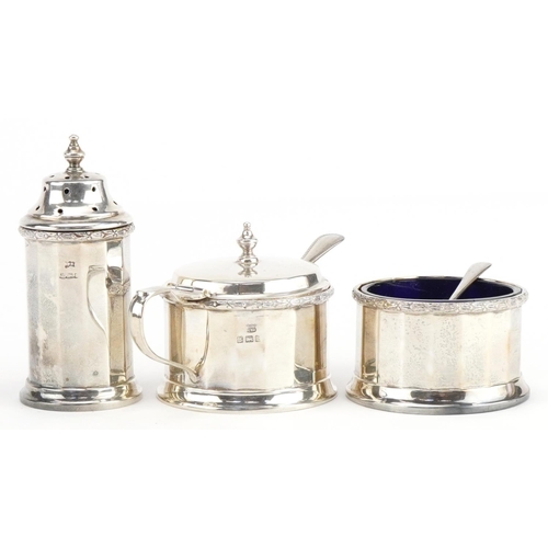 639 - William Neale & Son Ltd, George V silver three piece cruet set with blue glass liners housed in a fi... 