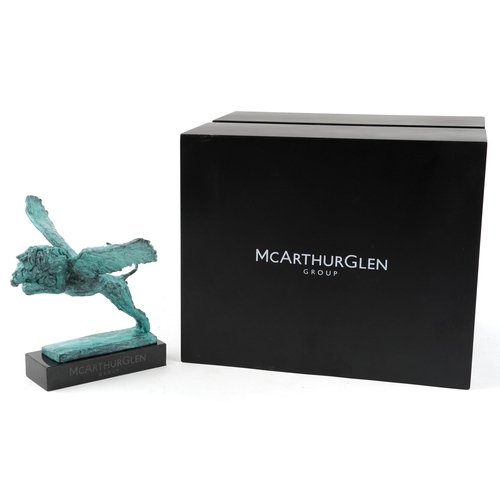 545 - Mark Coreth for McArthur Glen Group, Verdigris bronze statue of a winged lion raised on a slate base... 