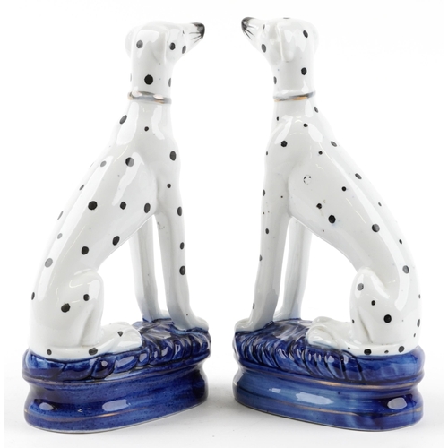 2458 - Pair of Staffordshire pottery Dalmatians, each 22cm high