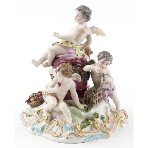 243 - Manner of Meissen, 19th century porcelain 'Vintner' centrepiece modelled in the form of three Putti ... 