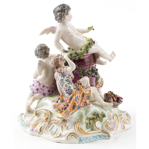 243 - Manner of Meissen, 19th century porcelain 'Vintner' centrepiece modelled in the form of three Putti ... 