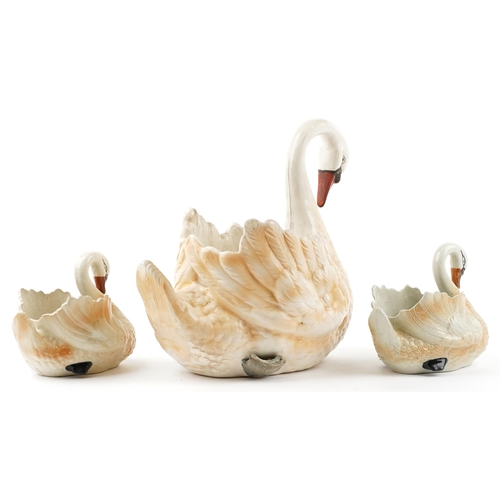 2510 - Three hand painted ceramic planters in the form of swans, the largest 44cm in length