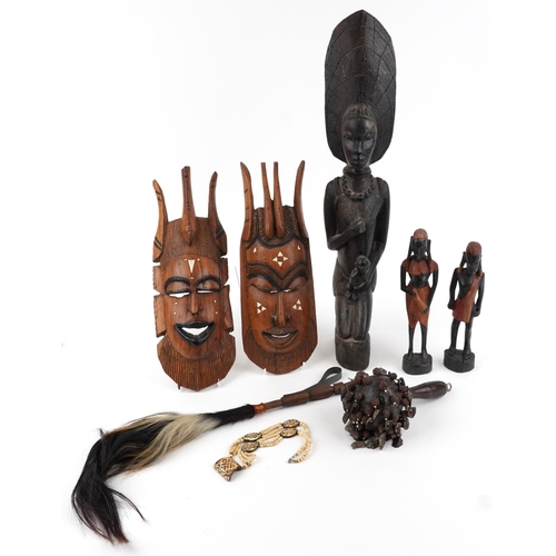 2491 - Tribal hardwood carvings including a large heavy figure of a mother with child and a carved bone nec... 